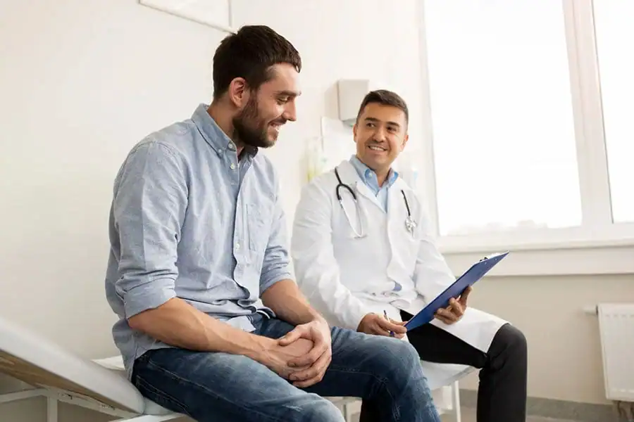 Man discussing his health with a clinician during a consultation