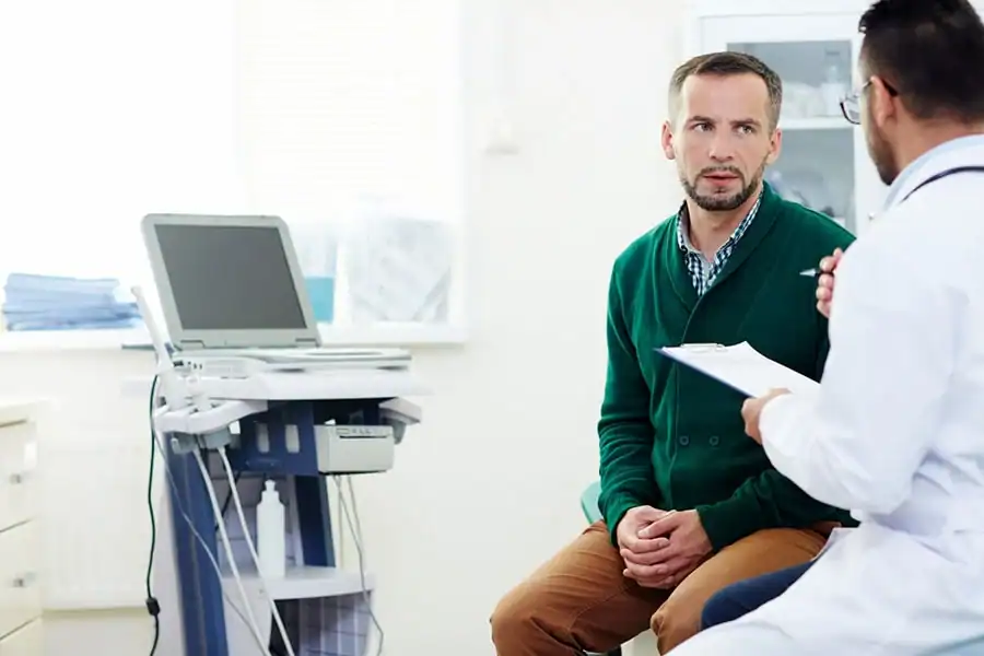 Patient speaking with a clinician during a medical appointment