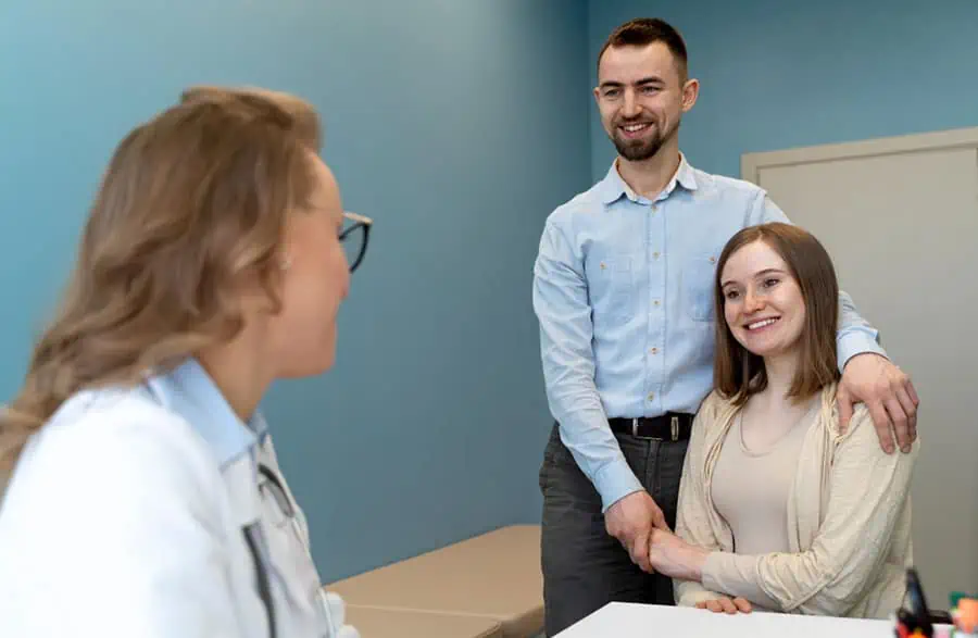 A couple meets with a clinician during a women's health consultation