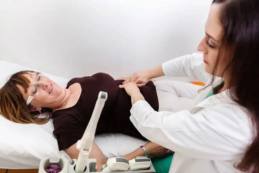 A gynecologist examining a mature patient