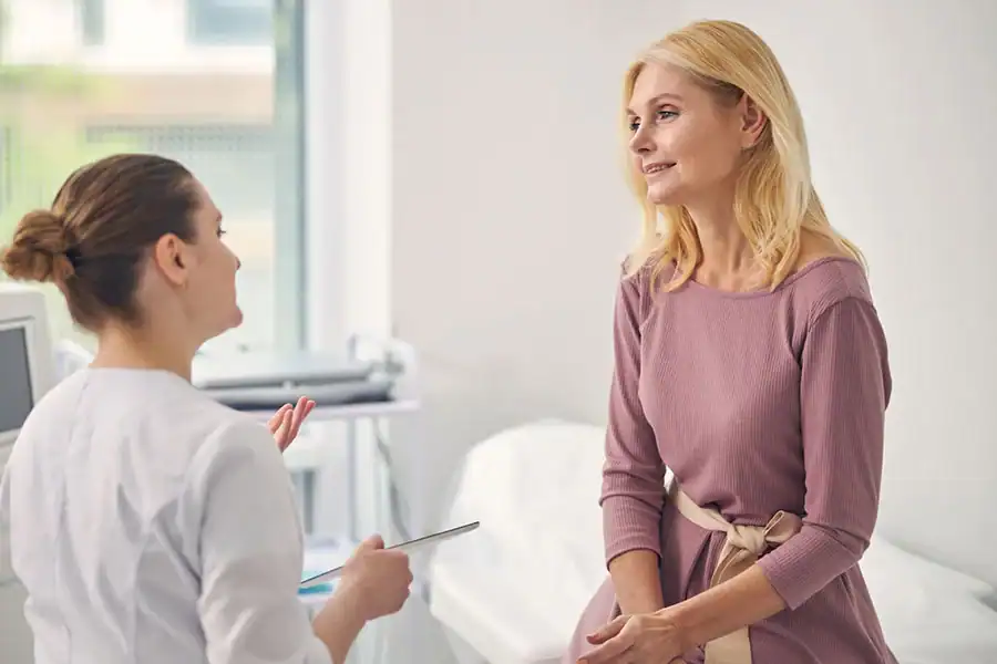 A patient listening as her clinician discusses menopause symptoms