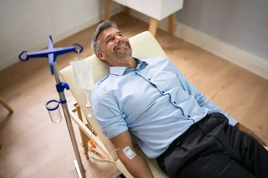 A patient receiving supervised IV hydration