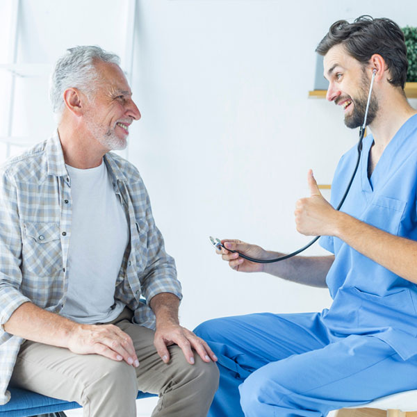 A primary care doctor encouraging an older patient